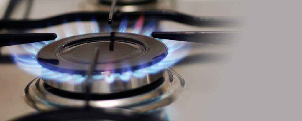 Blue gas burner flame on commercial cooktop